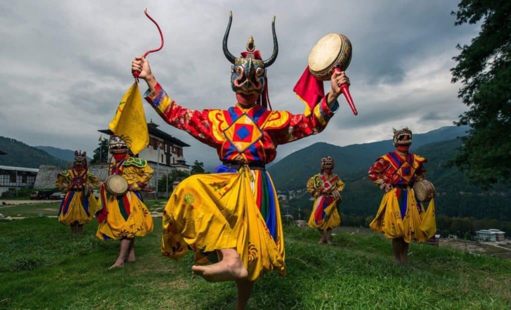 Bailarines butaneses coloridos con trajes tradicionales se presentan durante un festival vibrante